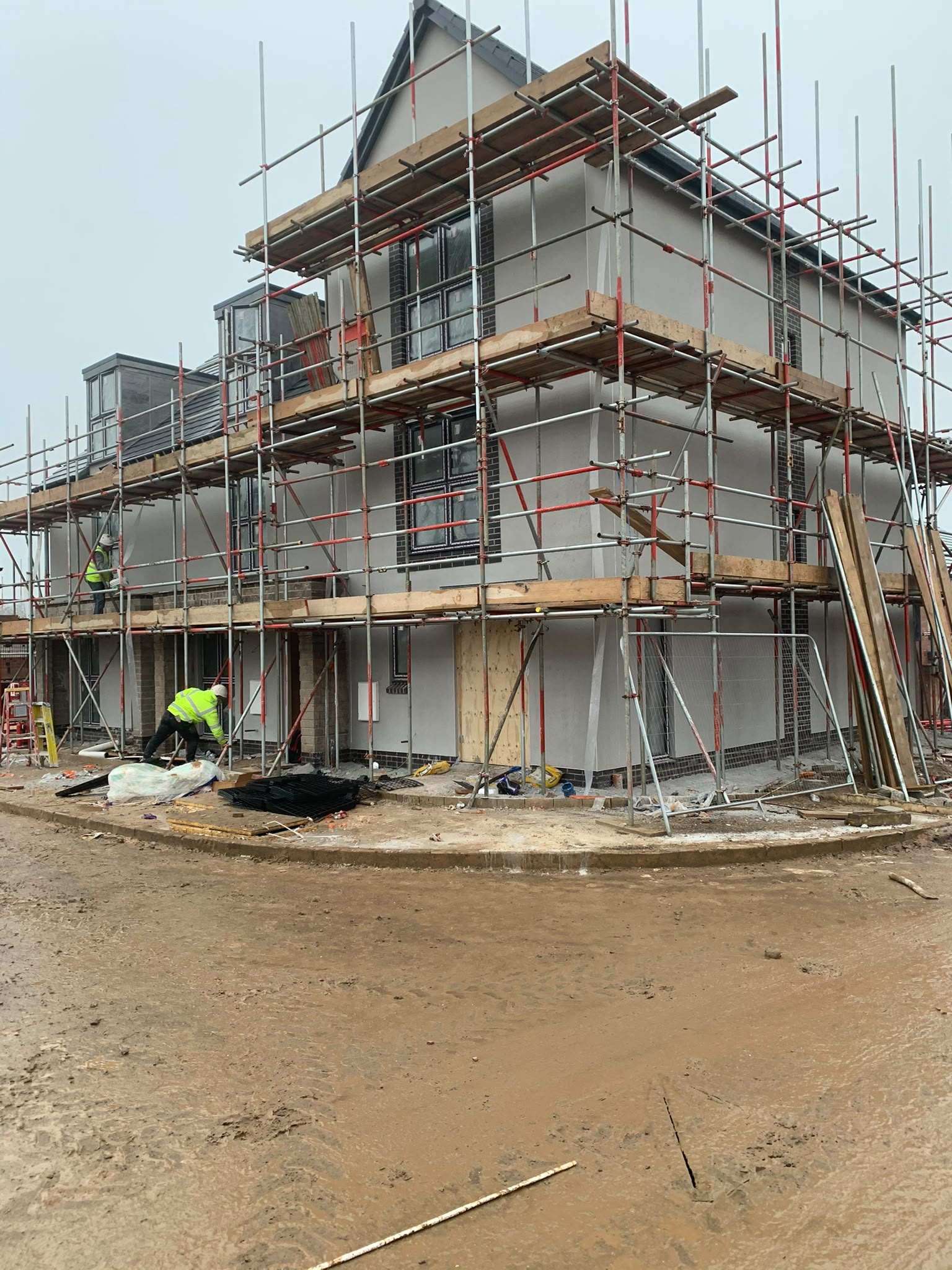 Silicone render installation in progress with scaffolding